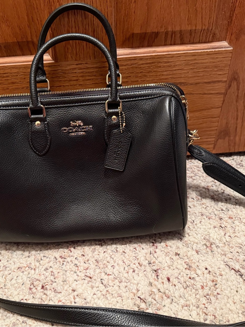 Coach Black pebble leather Large Rowan.  The older style with crossbody strap.